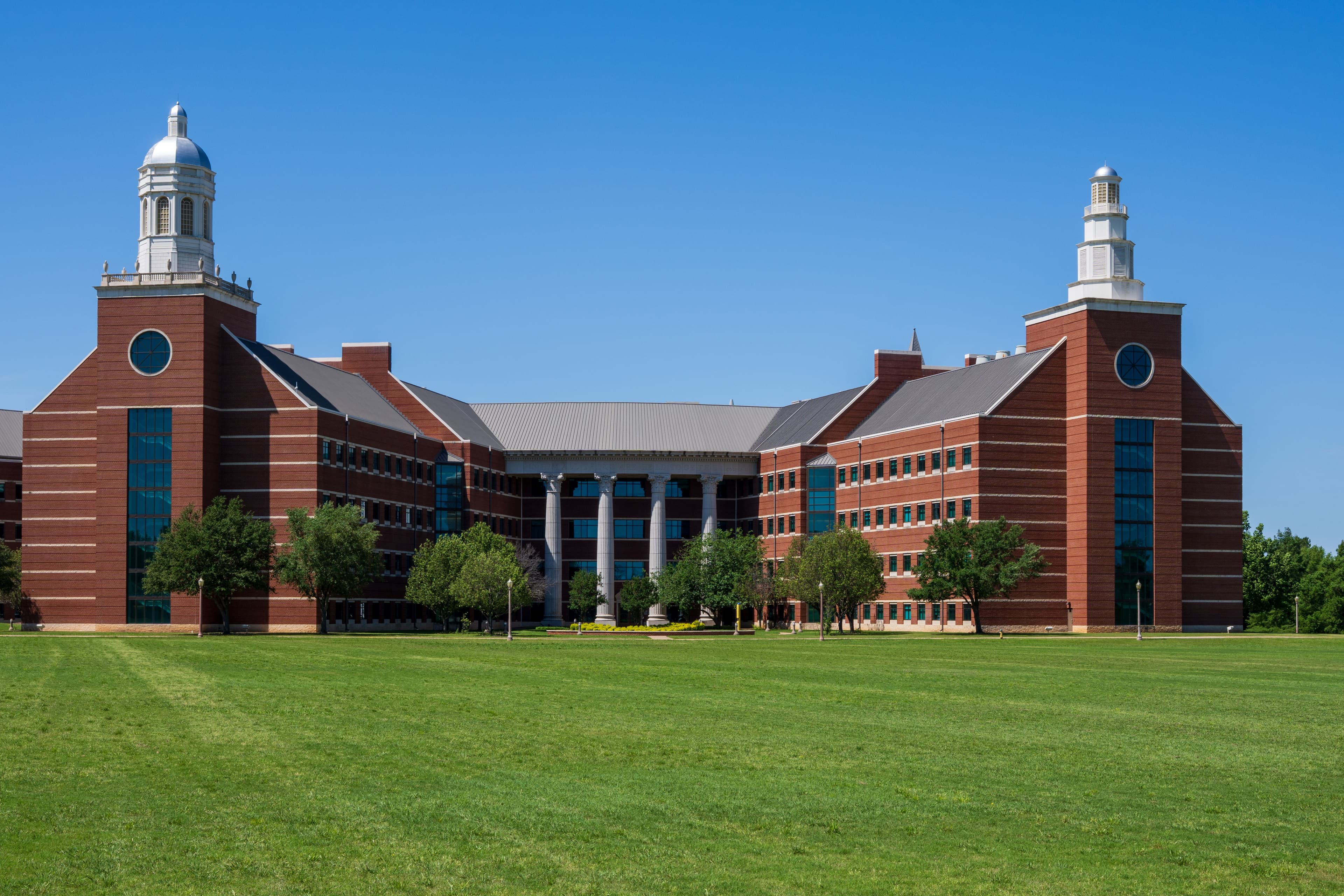 Stately brick university hall facing a wide lawn