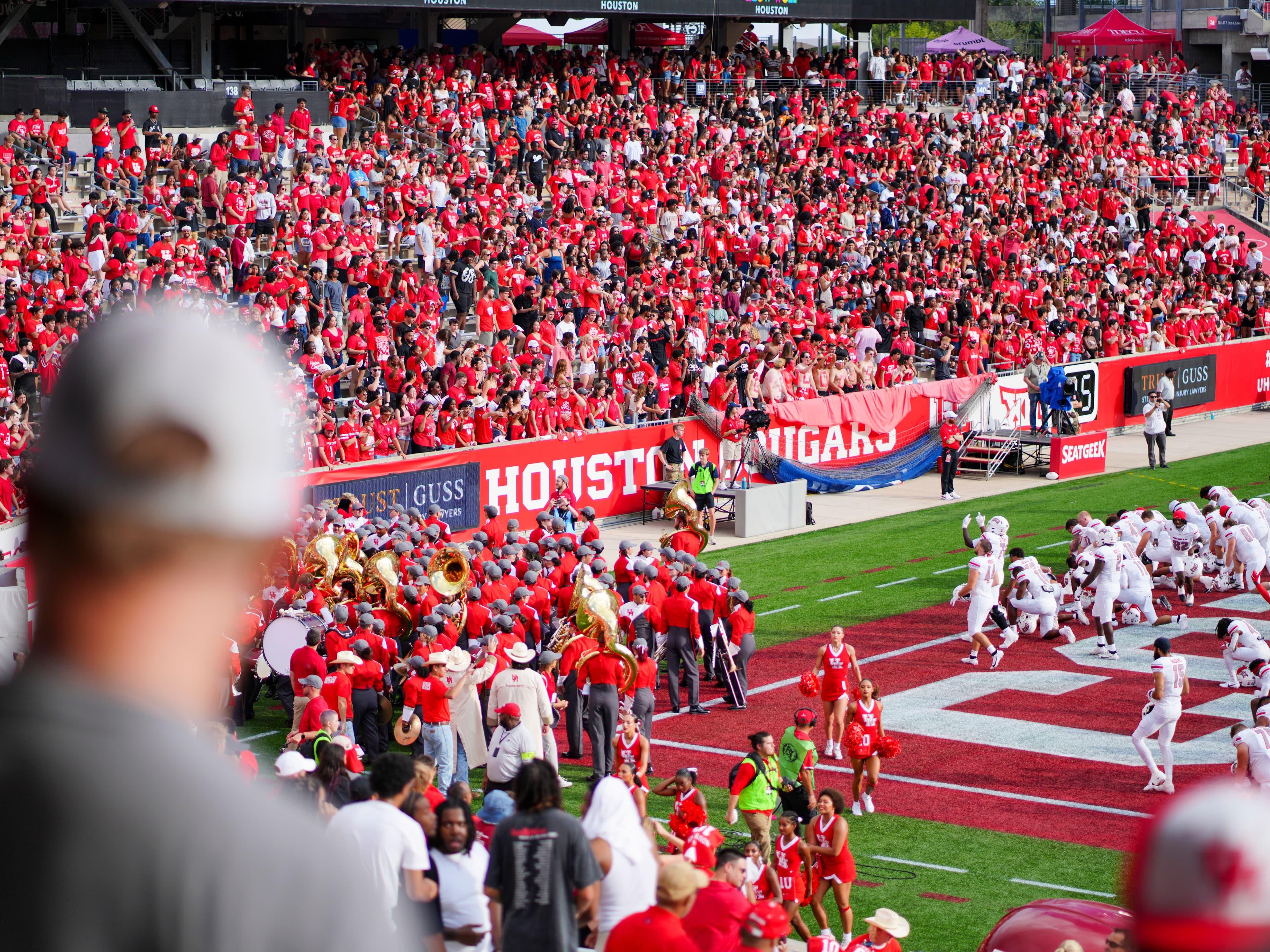 Wide shot of a packed college football stadium during a game